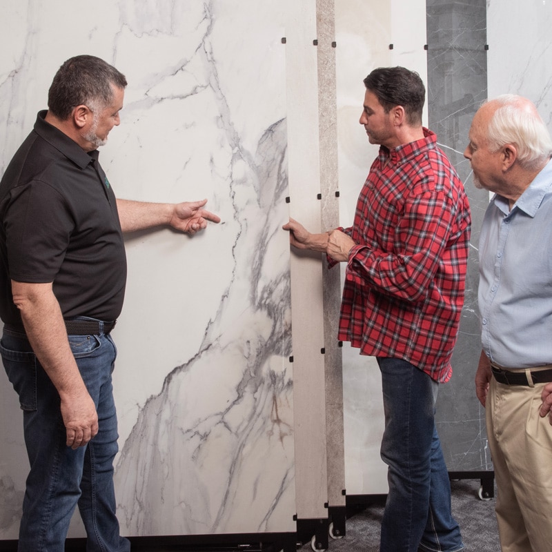 three men looking at the pattern details on porcelain tile displays