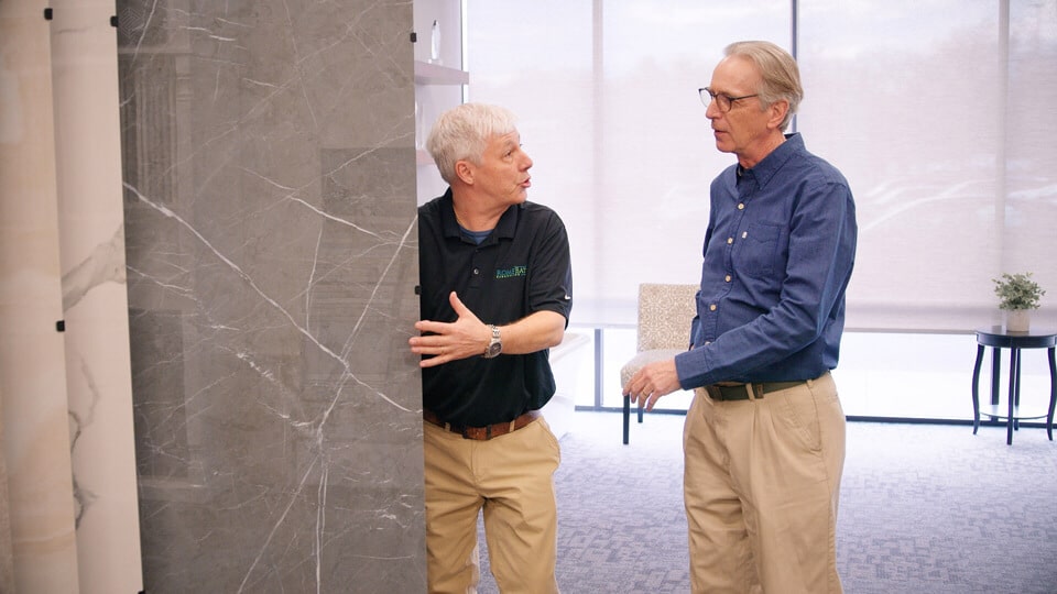 showroom employee talking about bathroom remodel design options