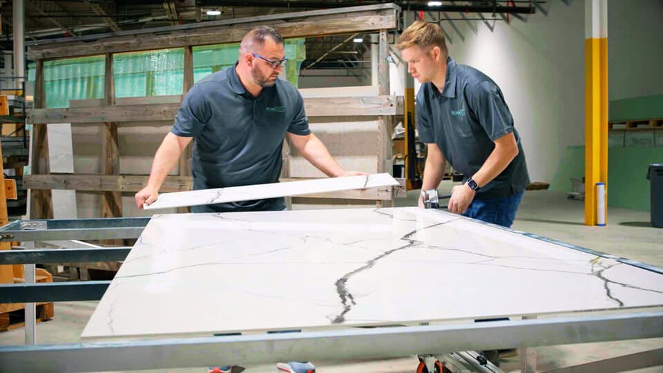 bathroom installers cutting tile for remodel