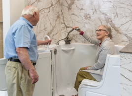 older couple checking out the new features of walk-in bath safety and accessible tubs