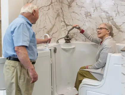 elderly couple checking out a new walk-in tub in a Rome Bath Remodeling showroom