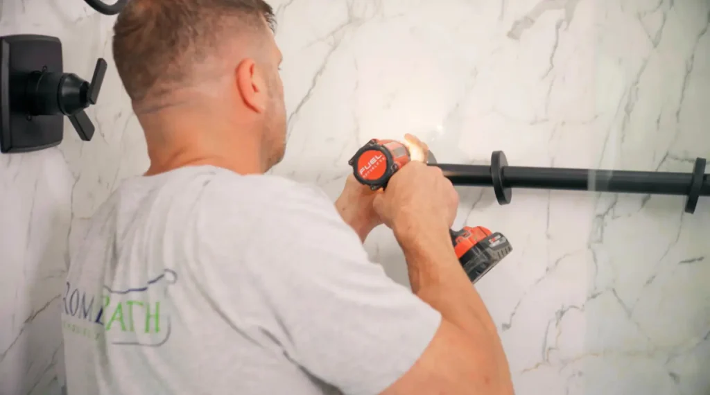rome bath remodeling employee installing a safety and accessibility hand bar for extra support
