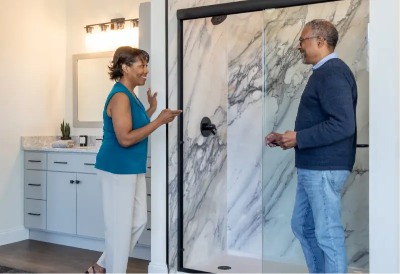 Customers Looking at Large Format Porcelain Showers at a Rome Bath Remodeling Showroom