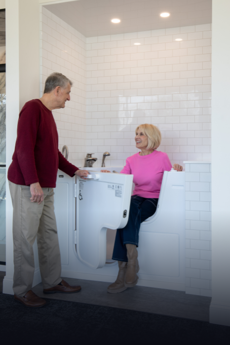 couple in a rome bath remodeling showroom testing out a walk-in bathtub