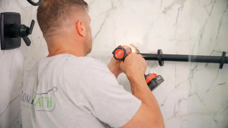 rome bath remodeling employee adding safety and accessibility hand grabs to a recent bathroom remodel