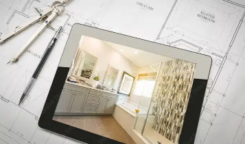ipad and design tools on top of blueprints for a room