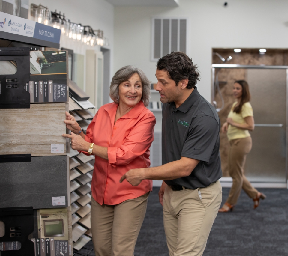 Employee helping customer choose flooring
