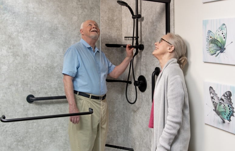 two rome bath remodeling customers testing out shower fixtures and features
