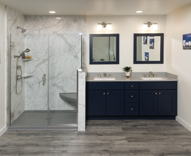 newly remodeled bathroom with glass wall walk-in shower next to a double vanity with matching sinks and mirrors