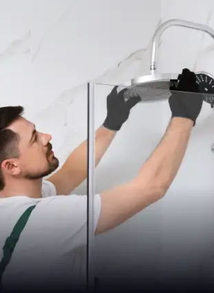installer installing a shower head in a walk-in shower