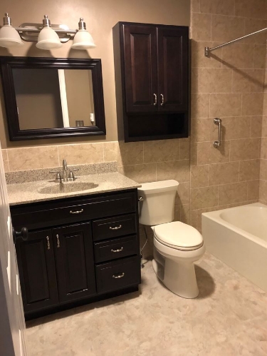 bathroom remodel with new tub vanity toilet flooring and lighting fixtures