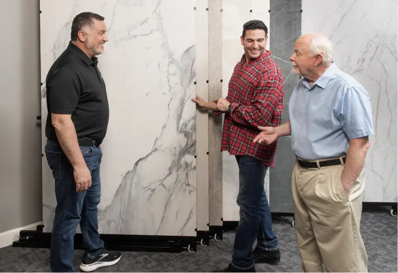 the owner of rome bath remodeling showing customers the brand new large format tile options in our showrooms