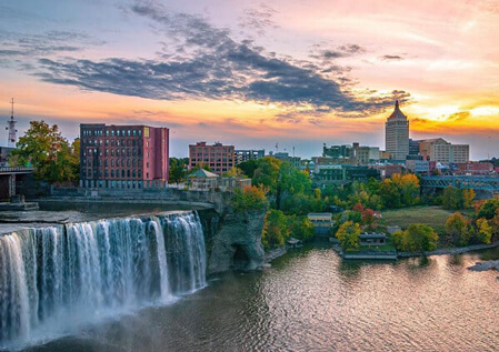 rochester new york city during sunset with waterfall in front